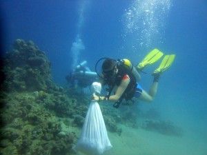 diver with bag of debris