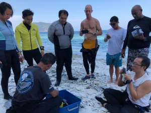 The participants are listening carefully how to cut the Coral pulp