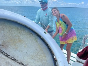 Captain Oscar and deckhand Brooke posing with the retrieved debris onboard the Phoenix vessel 