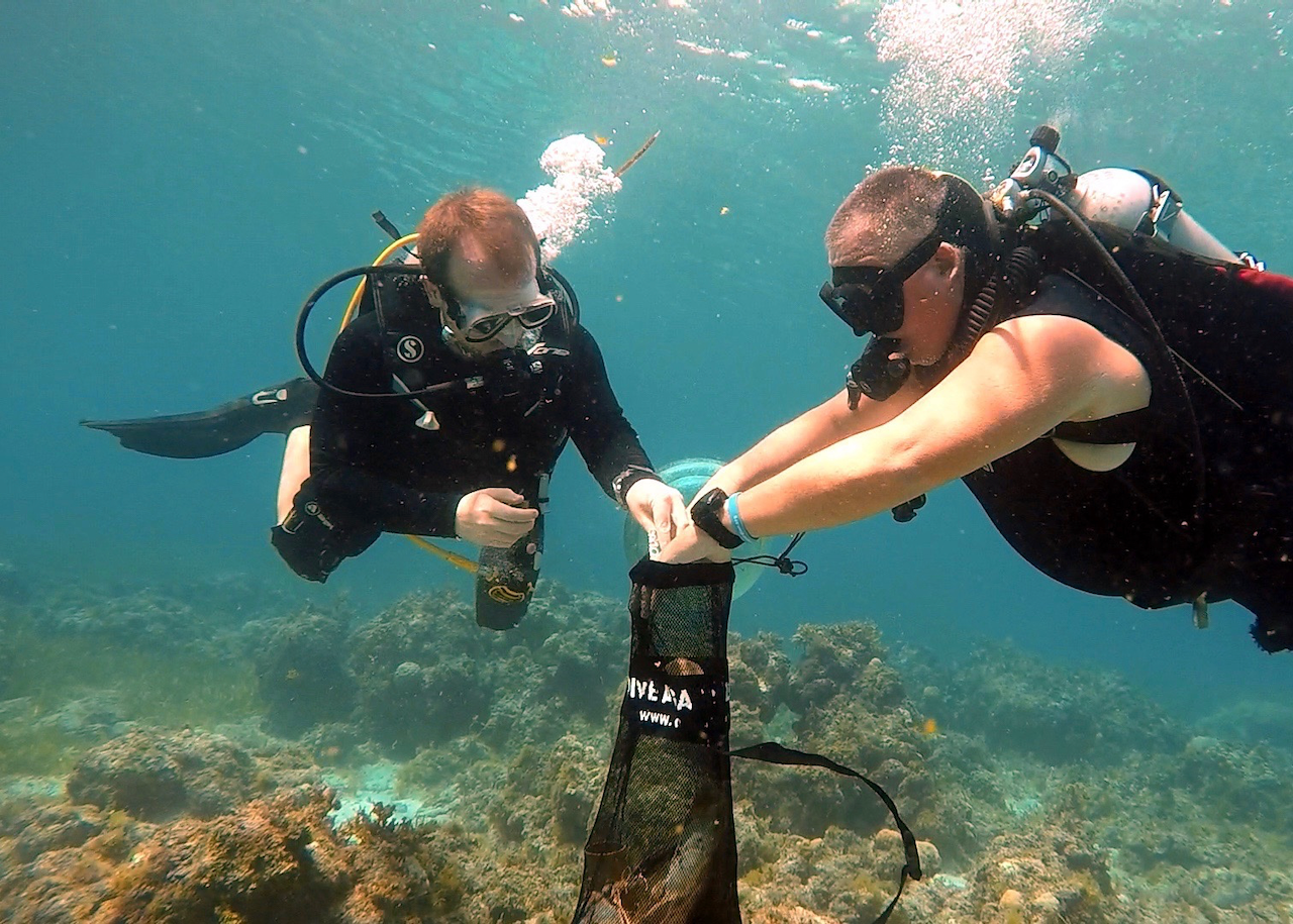 Picking up trash underwater