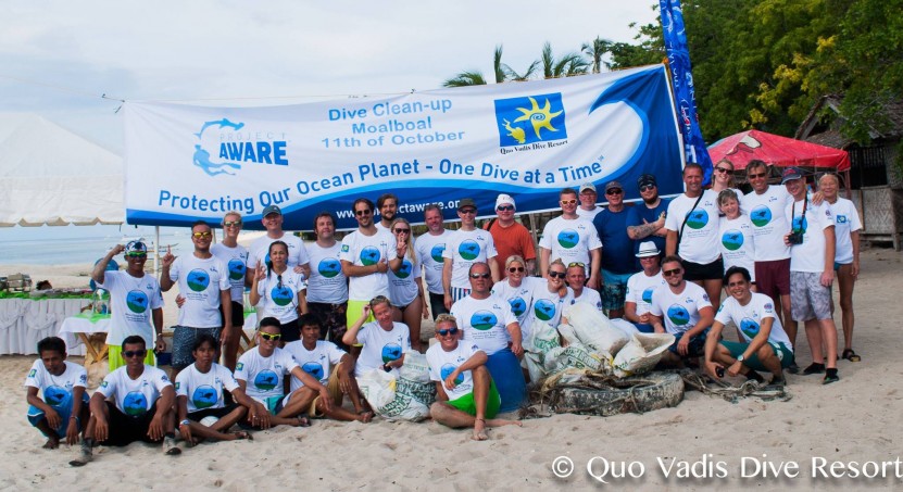 Happy volunteers on the beach after picking up 118 kg of trash from the ocean bed