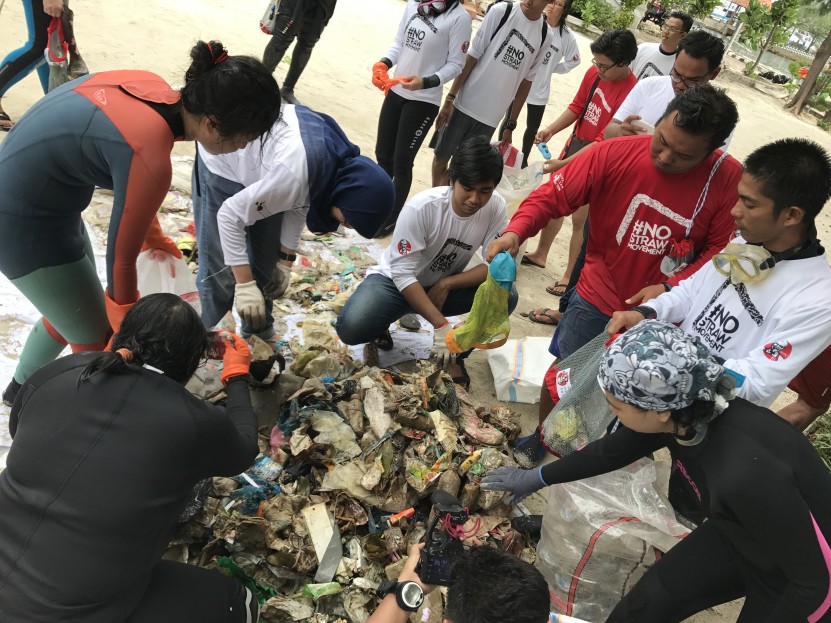 Scuba divers sorting the trash after the dive