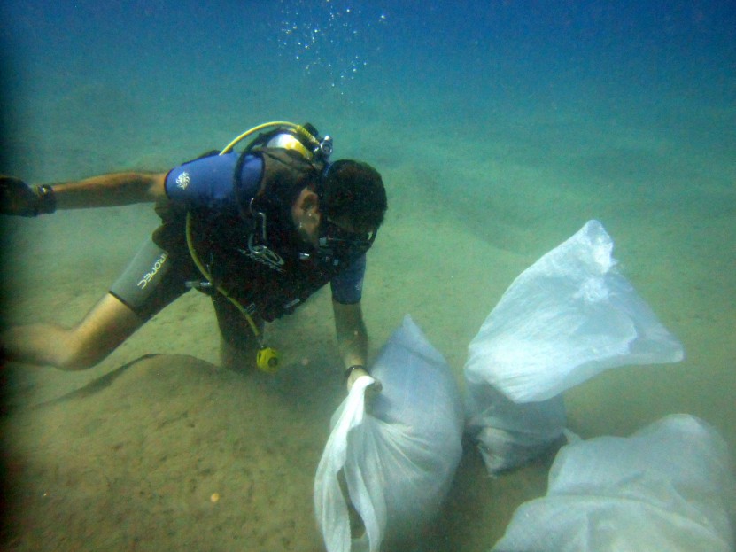 diver with bags of debris