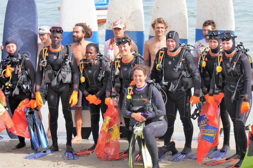 Scuba divers and surfer team