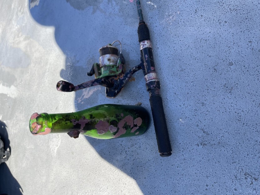 fishing rod and glass bottle