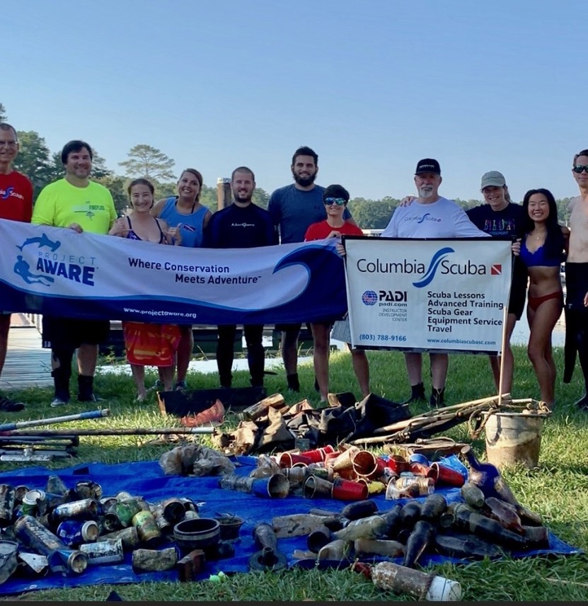 Image of divers in front of debris collected from the lake.