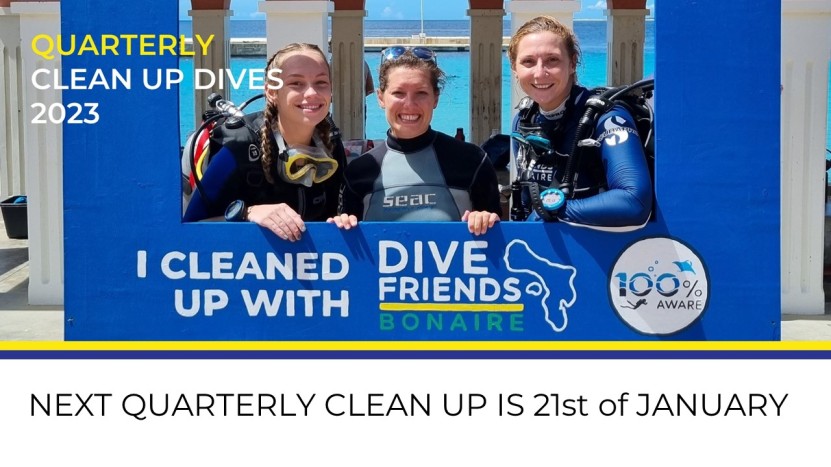 Photo of three people who joined the clean up last time. They are posing in a special photobooth for pictures that says I cleaned up with Dive Friends Bonaire and PADI AWARE.