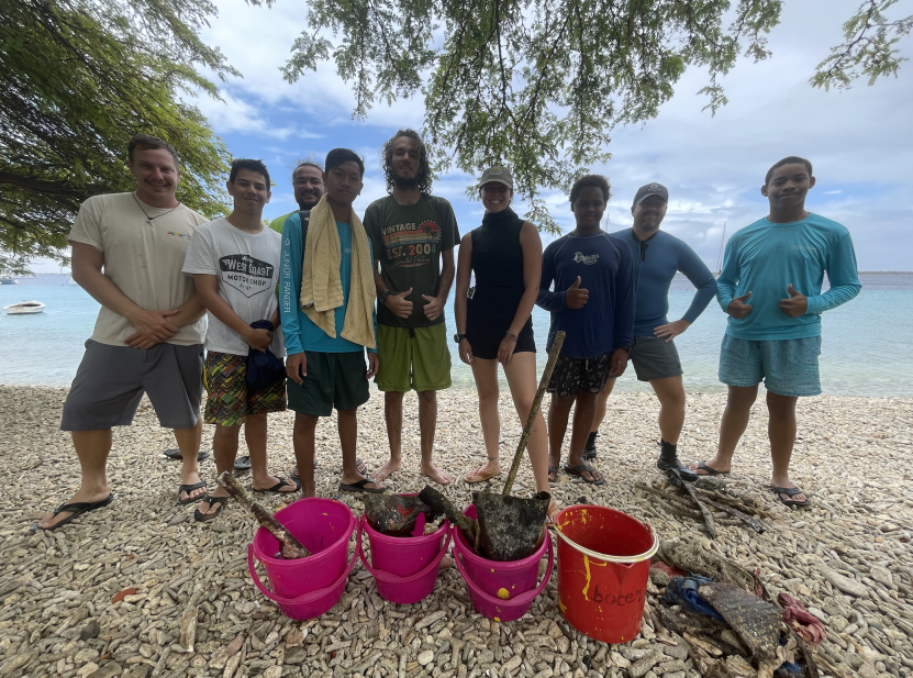 The divers standing next to the debris collected.