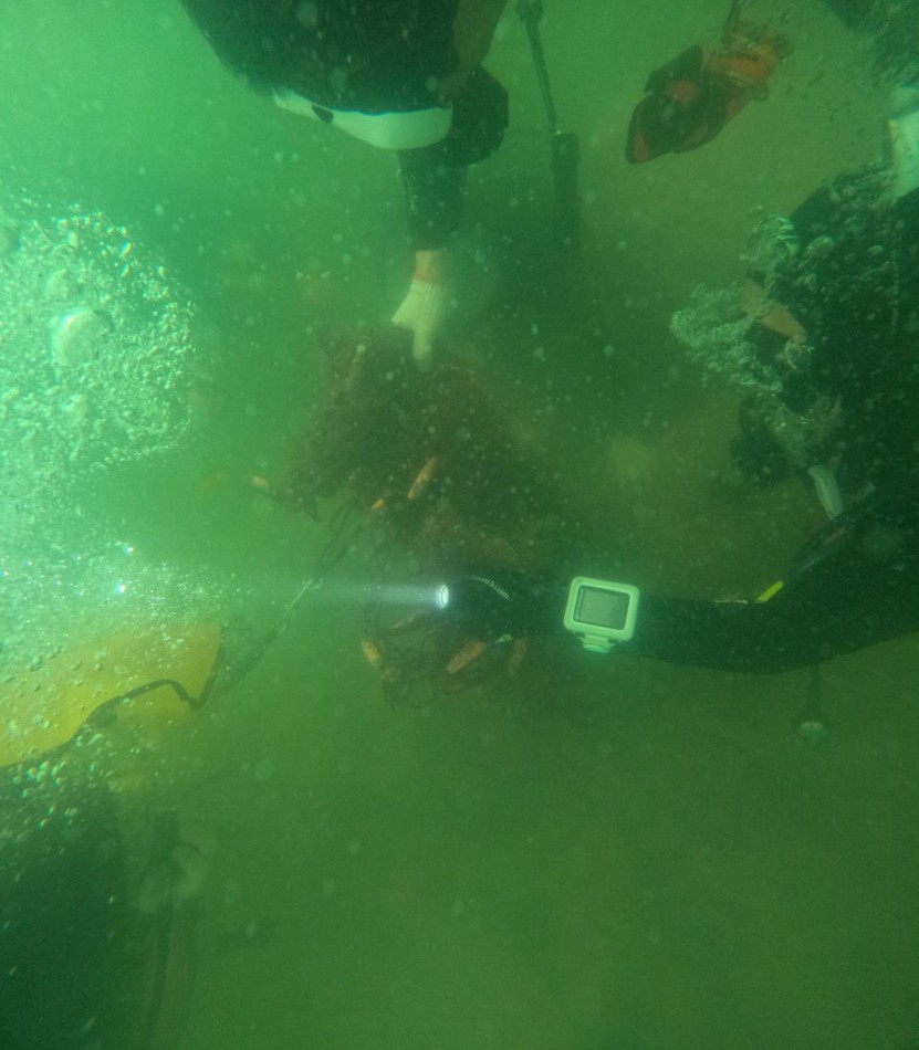 Picking ocean debris on ocean floor 