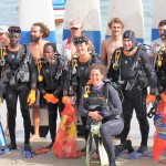 Scuba divers and surfer team