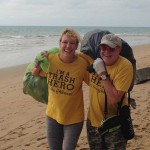 Collecting trash on a beach clean up.