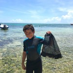 Marc on the beach after his dive, with his recovered debris