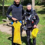 Two Divers waiting to sort and record the trash that they brought up fo